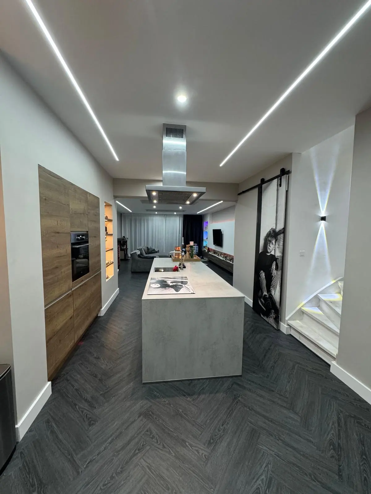 Open keuken met kookeiland en schuifdeur na een totaalrenovatie