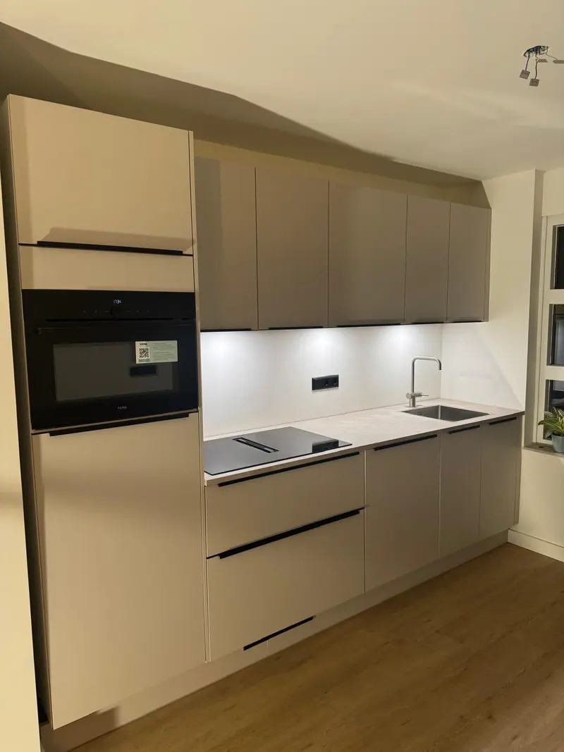 Strakke witte keuken met inbouwapparatuur