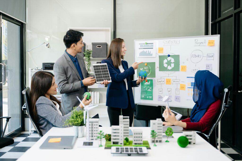 Business people having consultation about wind energy at company office.